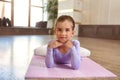 Baby girl wearing a peach tutu. a smiling baby girl lying on the floor on a sports mat Royalty Free Stock Photo