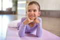 Baby girl wearing a peach tutu. a smiling baby girl lying on the floor on a sports mat Royalty Free Stock Photo