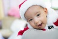 Baby girl wearing red Santa Claus costume she sit on father`s shoulder. she happy and smile. Royalty Free Stock Photo