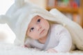 Baby girl wearing white towel or winter overal in white sunny bedroom Royalty Free Stock Photo