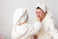 mother and daughter in bathrobes at home Royalty Free Stock Photo