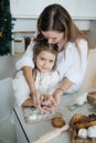 Baby girl in white and mother near Christmas