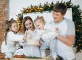 Baby girl in white and mother near Christmas