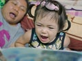 A baby girl, 2 years old, reading aloud, repeating after her auntie, a bedtime story