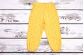 Baby-girl yellow printed trousers. Royalty Free Stock Photo