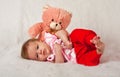 Baby girly lying in front of a pink teddie Royalty Free Stock Photo