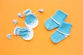 Baby gloves and socks on orange background Royalty Free Stock Photo