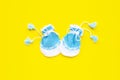 Baby gloves on yellow background Royalty Free Stock Photo