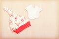 Baby goods. Children`s clothing, hat with flowers and white gloves on the background of the changing table. Royalty Free Stock Photo