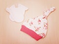 Baby goods. Children`s clothing, hat with flowers and white gloves on the background of the changing table. Royalty Free Stock Photo