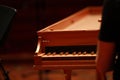 Baby grand piano, piano keys, golden piano keys on an old baroque clavichord