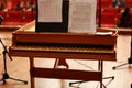 Baby grand piano, piano keys, golden piano keys on an old baroque clavichord