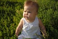 Baby on the grass, wind blowing Royalty Free Stock Photo