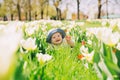Baby in green grass of tulip field at springtime Royalty Free Stock Photo
