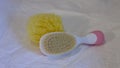 A baby hairbrush and a yellow sponge for the baby`s bath Marche, Italy Royalty Free Stock Photo