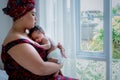 Baby half Nigerian half Thai, is 2-month-old baby newborn son, sleeping and happiness with his mother being held,