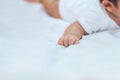 Baby hand on the bed, soft focus newborn tiny hand. Royalty Free Stock Photo