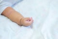 Baby hand on the bed, soft focus newborn tiny hand. Royalty Free Stock Photo