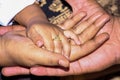 Baby hand. Closeup of baby hand into parents hands. Family Baby Hands. Father and Mother Holding Newborn Kid. Child Hand Closeup Royalty Free Stock Photo