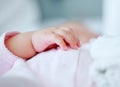 Baby, hand and closeup in bed for sleeping, health and growth with comfort, blanket and tired in house. Infant, child Royalty Free Stock Photo