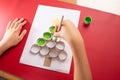 baby hand drawing Christmas tree, paper craft made of empty toilet paper roll Royalty Free Stock Photo