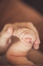 Baby hand gently holding adult's finger Royalty Free Stock Photo