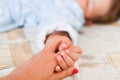 Baby hand gently holding parent finger. Family concept. Royalty Free Stock Photo