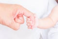 Baby hand holding adult finger Royalty Free Stock Photo