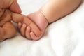 Baby hand holding mother finger. Royalty Free Stock Photo