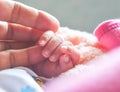 Baby hand holding mother's hand at the first time after birth that is lovely moment of the family.