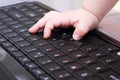 Baby hand on keyboard laptop Royalty Free Stock Photo