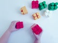 Baby hands playing colorful with plasticconstruction blocks on white background Royalty Free Stock Photo