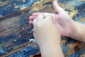 baby hands with sesame seeds on wooden Royalty Free Stock Photo