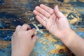 Baby hands with sesame seeds on wooden Royalty Free Stock Photo