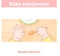 Baby hands on wood table. Baby equipment