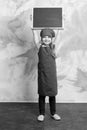 Baby, happy kid with banner board in kitchen or restaurant Royalty Free Stock Photo