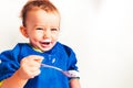 Baby happy and happy to be able to eat a yogurt leaving and laughing, on white