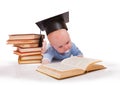 Baby in a hat of the bachelor and the book Royalty Free Stock Photo
