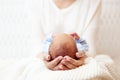 Baby Head in Mother Hands. Mum holding Newborn Boy lying on White Blanket. Infant Health Care and Development. Child Birth Royalty Free Stock Photo