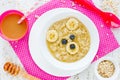 Baby healthy breakfast - oatmeal porridge with honey and banana Royalty Free Stock Photo