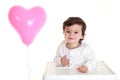 Baby with heart shaped balloon