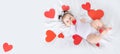 Baby among hearts on the bed, banner, place for text, valentine`s day concept