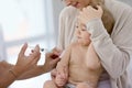 Baby with her mother getting vaccinated