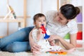 Baby and her mother play musical toys Royalty Free Stock Photo