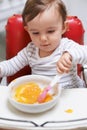 Baby, high chair and bowl for meal, nutrition or healthy porridge with spoon to eat food at home. Young adorable cute Royalty Free Stock Photo