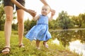 The baby with his mom takes the first steps in the park. Royalty Free Stock Photo