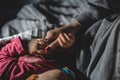 Baby hold her mothers hand while sleep close up on hand of small infant baby girl holding thumb of her mother unknown while sleep Royalty Free Stock Photo