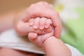 Baby hold mother finger in hand Royalty Free Stock Photo