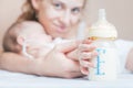 Baby holding a baby bottle with breast milk Royalty Free Stock Photo