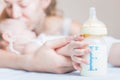 Baby holding a baby bottle with breast milk Royalty Free Stock Photo